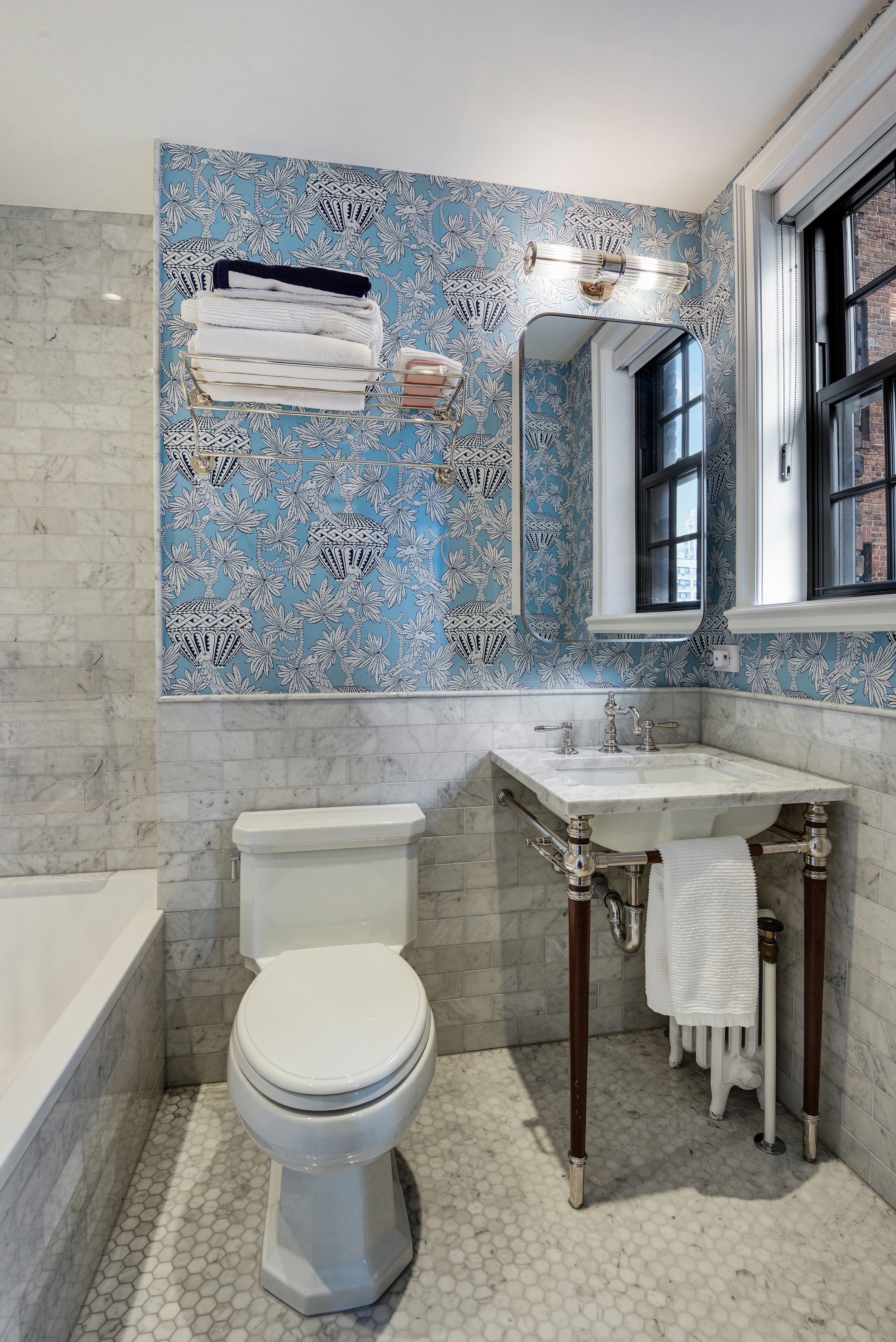 333 East 68th Street, Unit 6C Manhattan, NY 10065 - Photo 11 of 13 a bathroom with a toilet a sink and mirror