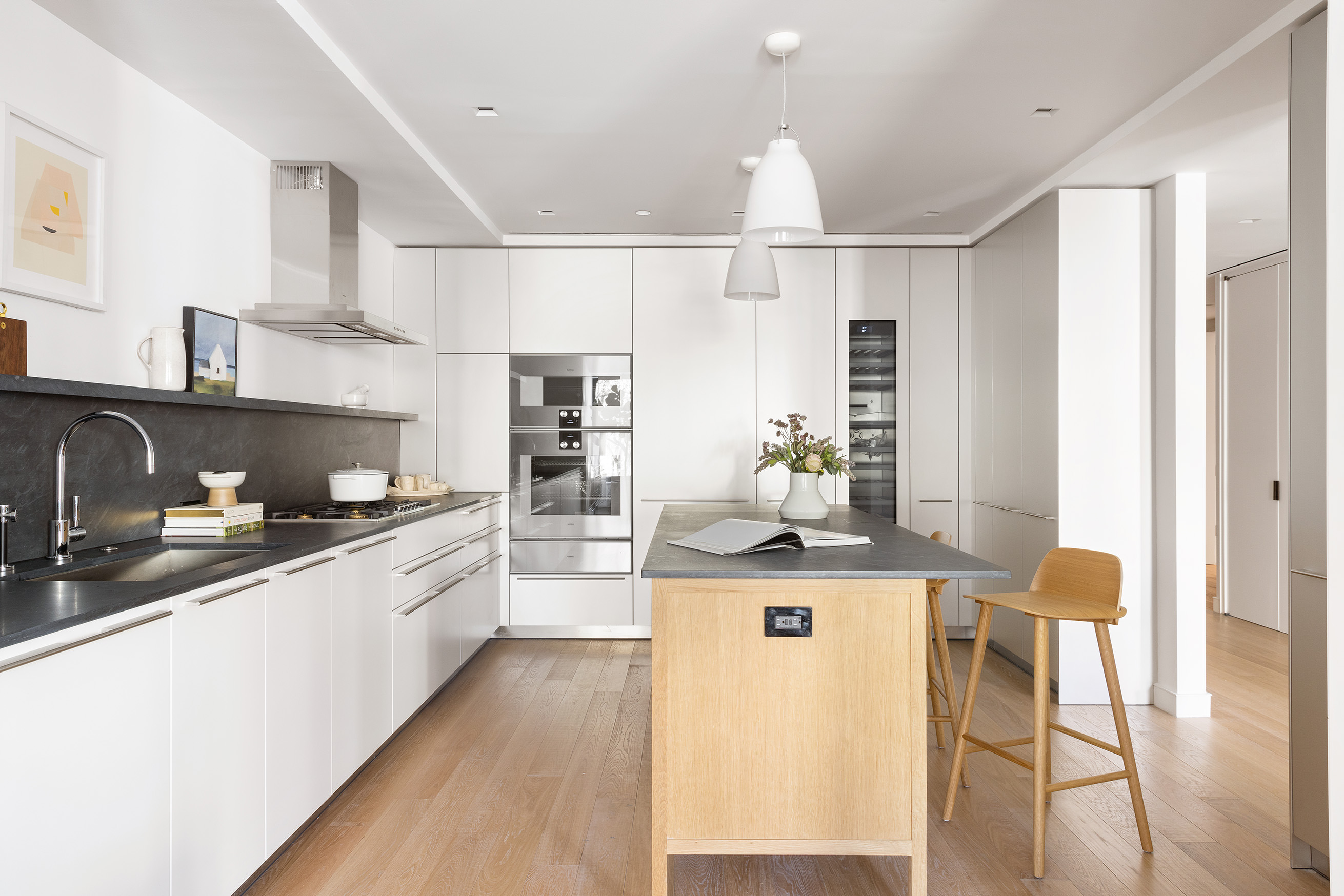 500 West 22nd Street, Unit 2A Manhattan, NY 10011 - Photo 3 of 19 a kitchen with granite countertop a sink stove and cabinets