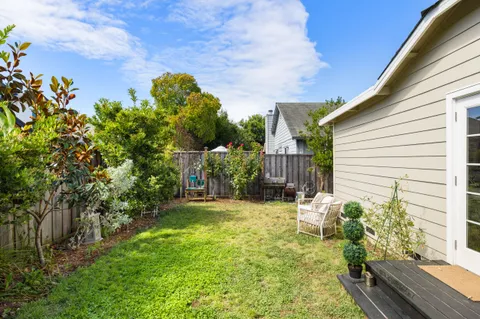 a view of a backyard with plants and a patio