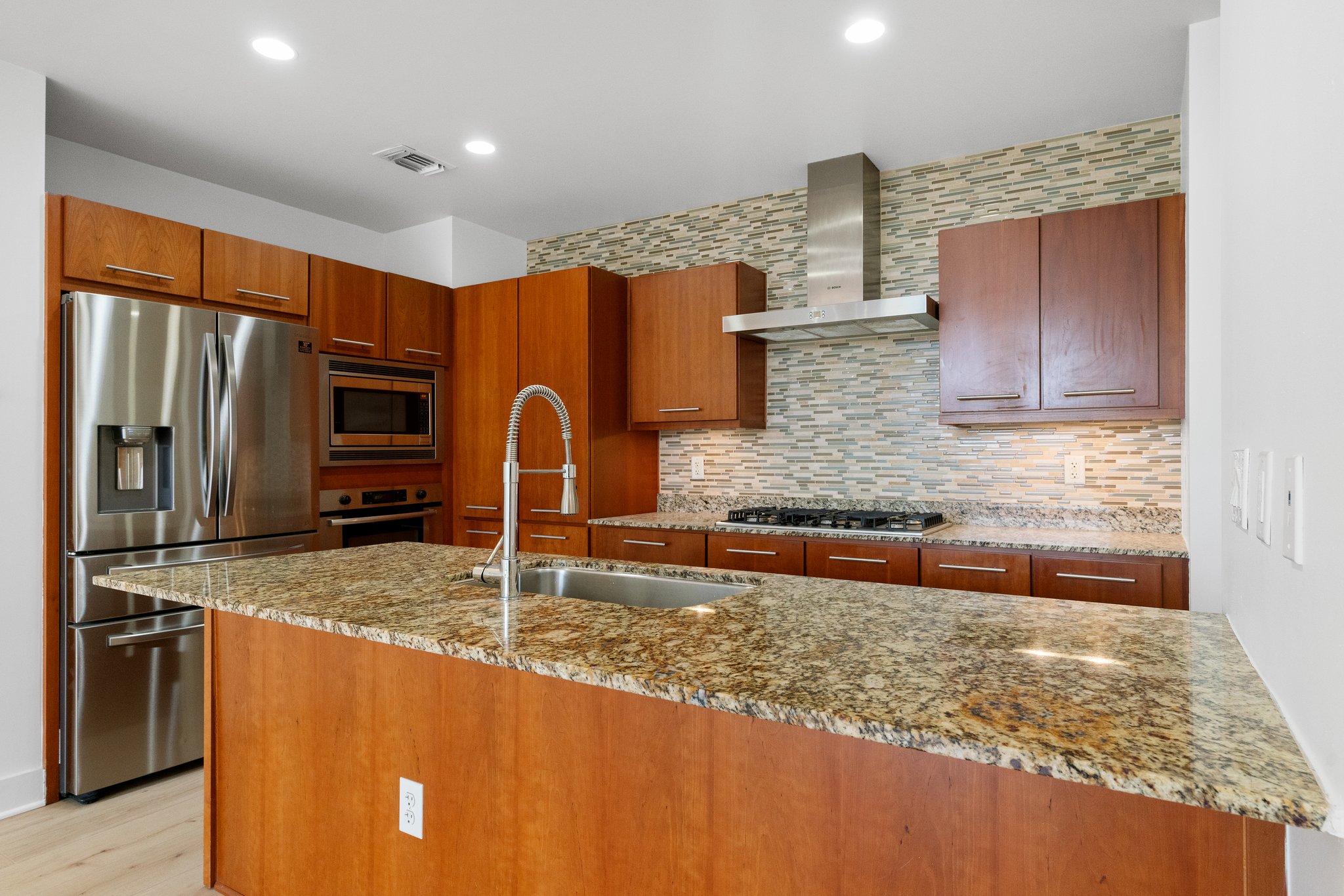210 Lee Barton Drive, Unit 517 Austin, TX 78704 - Photo 13 of 32 a kitchen with stainless steel appliances granite countertop a sink and a refrigerator