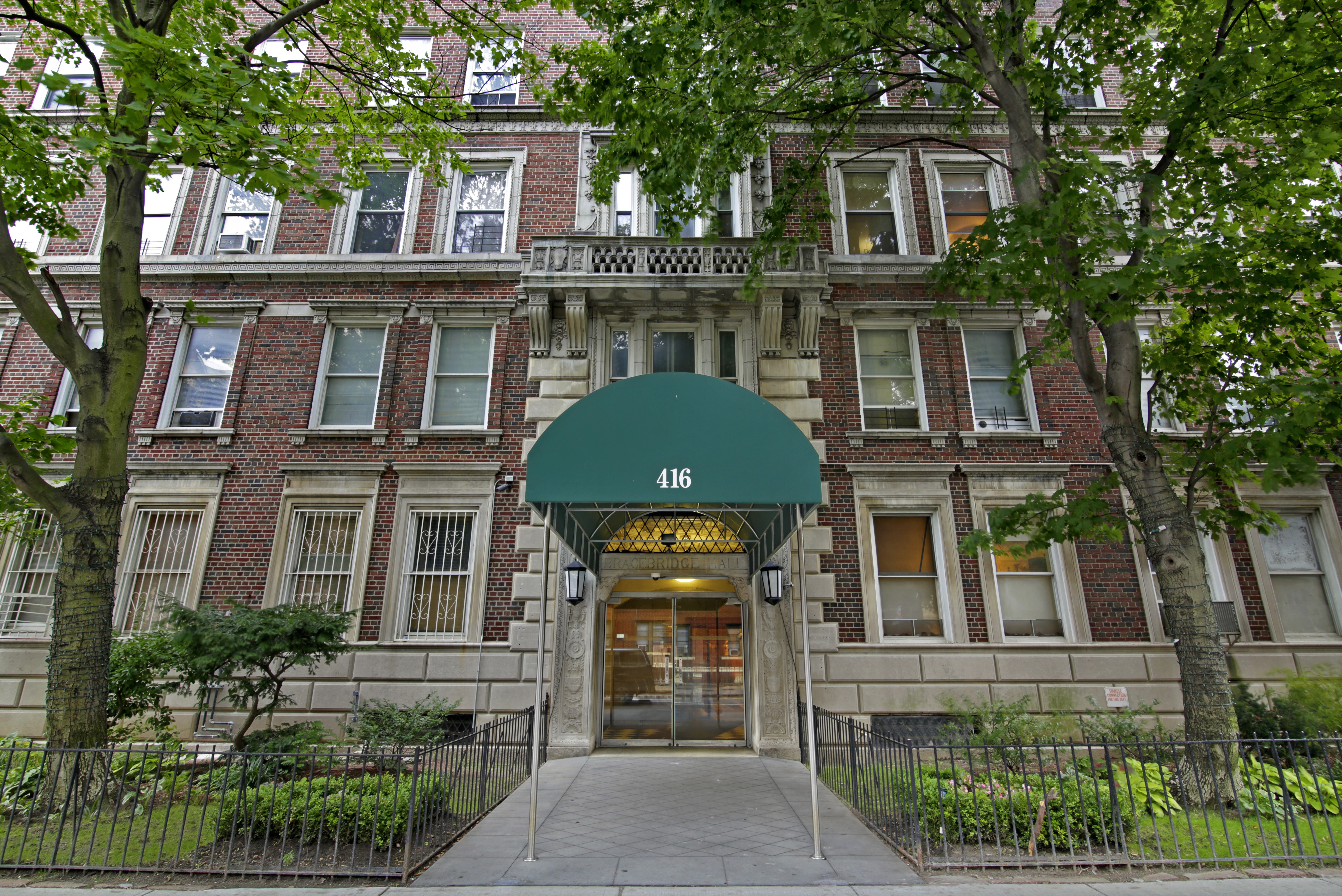416 Ocean Avenue, Unit 62 Brooklyn, NY 11226 - Photo 3 of 10 a front view of a house with a garden