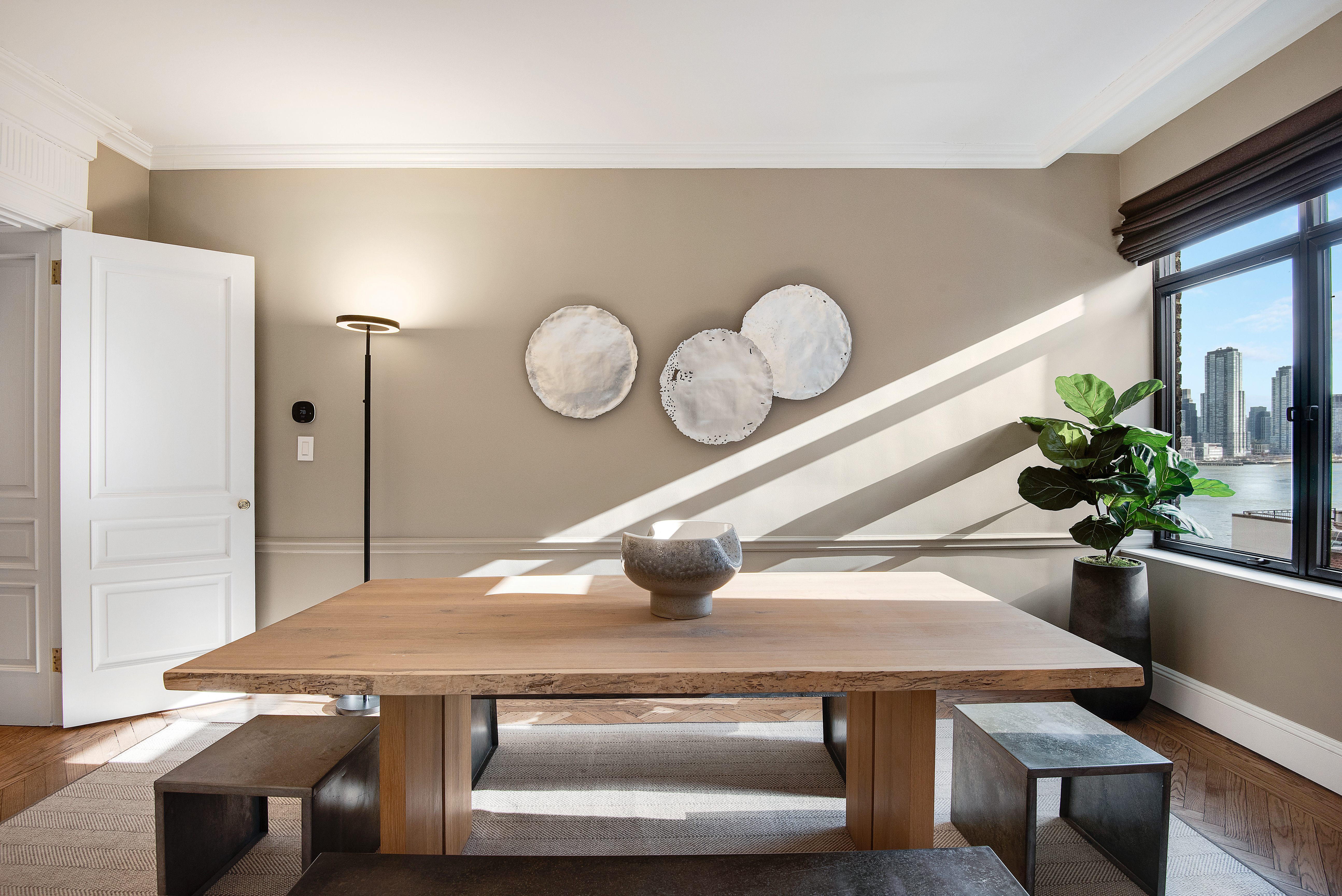 439 East 51st Street, Unit 8A Manhattan, NY 10022 - Photo 4 of 13 a kitchen with a stove a refrigerator a sink a dining table and chair