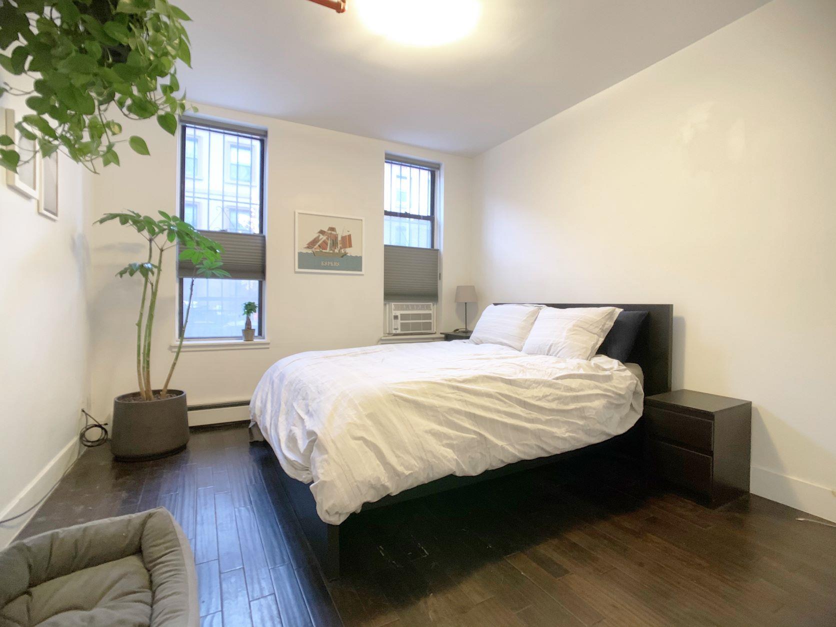 155 A 9th Street, Unit 1 Brooklyn, NY 11231 - Photo 6 of 15 a bedroom with a bed and a couch