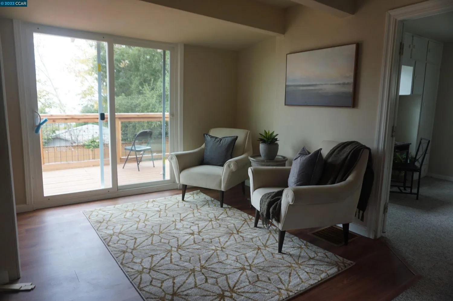 a living room with furniture and a floor to ceiling window