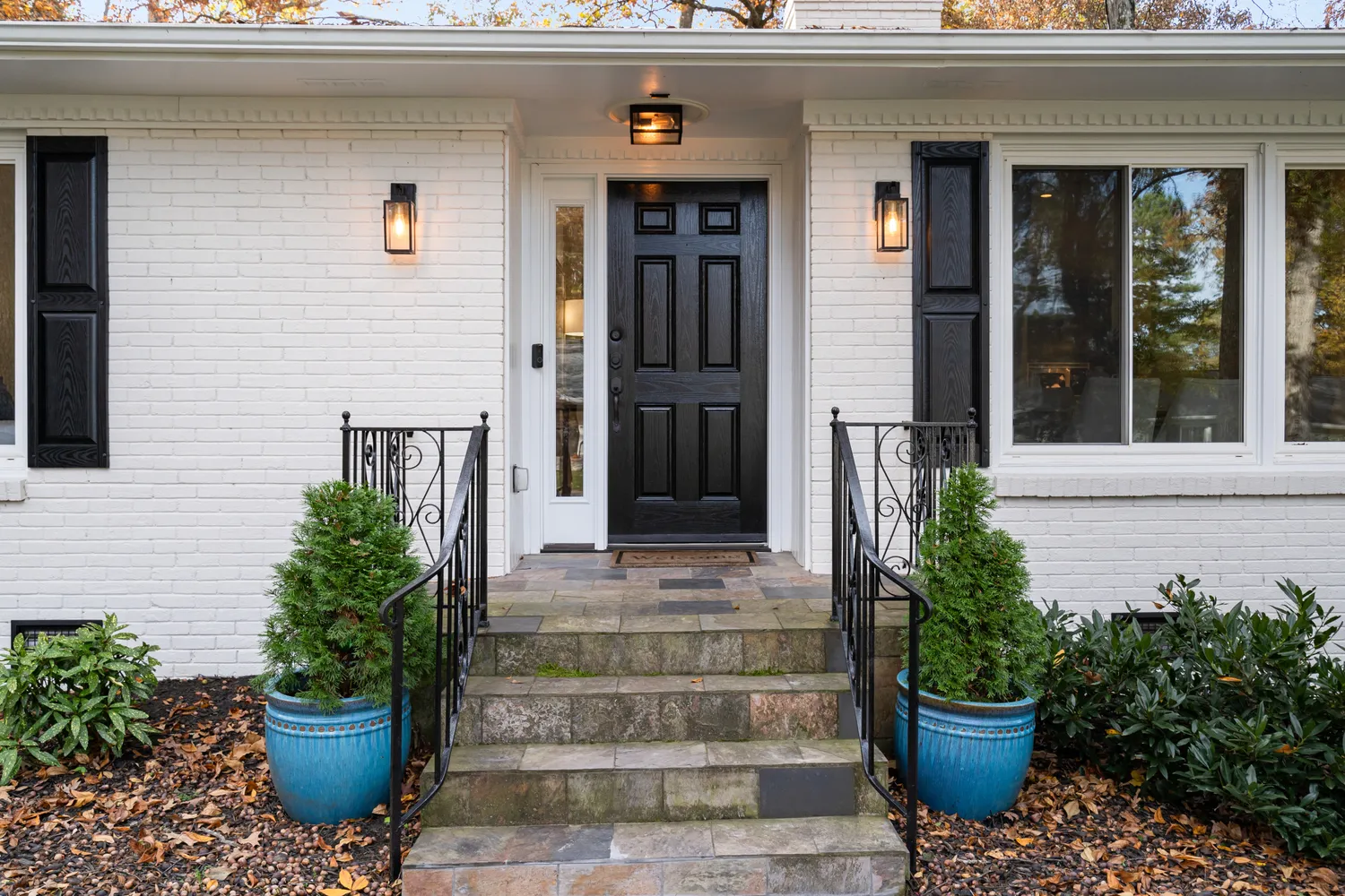 a view of a house with potted plants