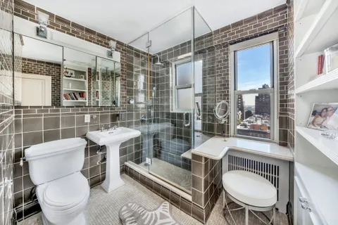 a bathroom with a toilet a sink and a shower