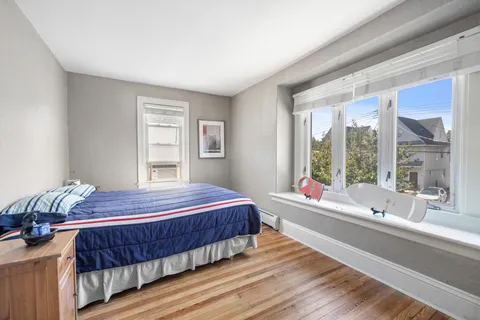 a bedroom with a large bed and a large window