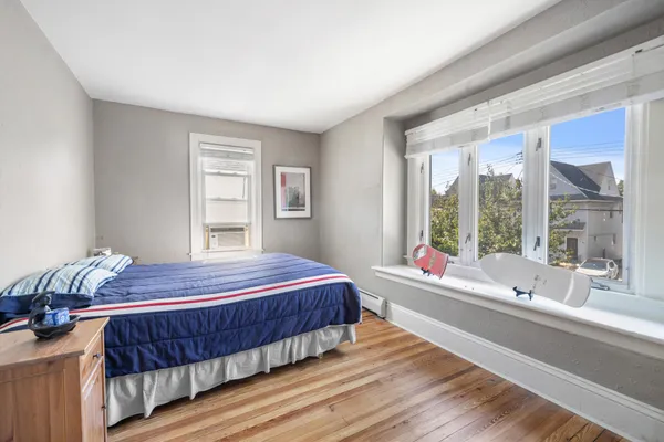 a bedroom with a large bed and a large window