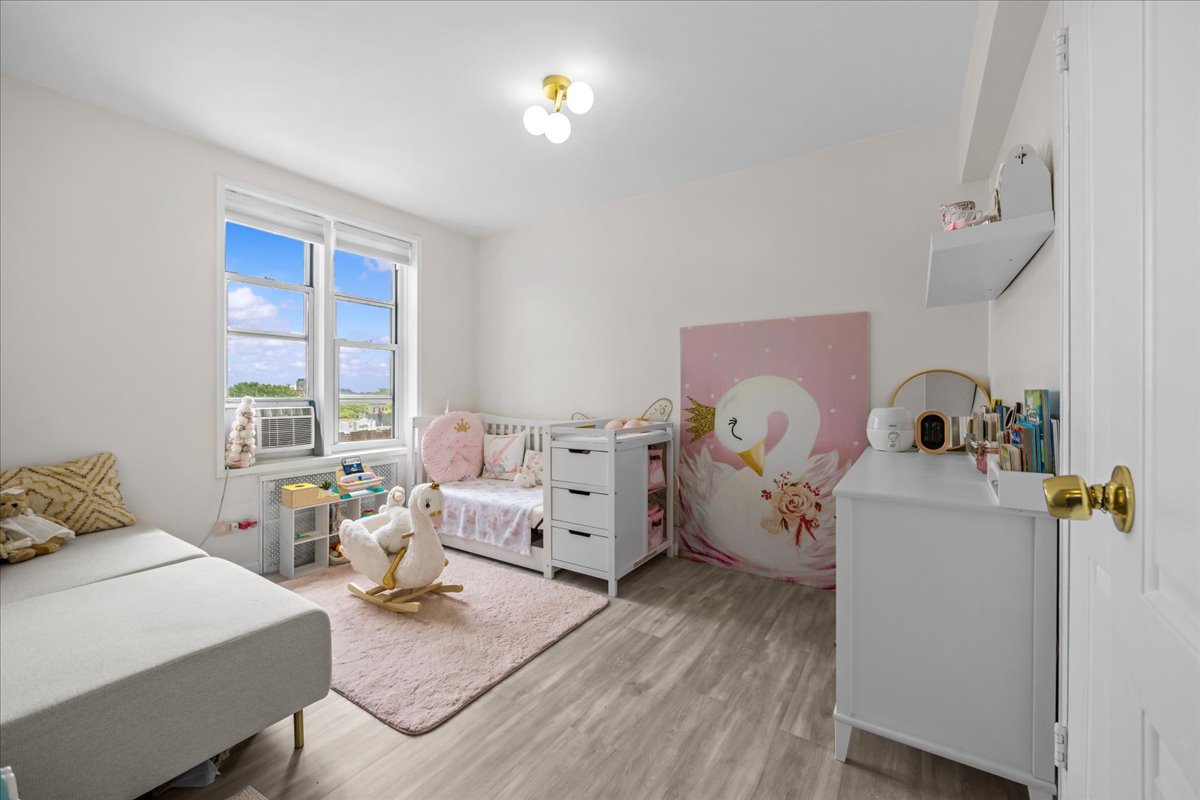 759 East 10th Street, Unit 7H Brooklyn, NY 11230 - Photo 10 of 15 a bed room with a bed and a chair