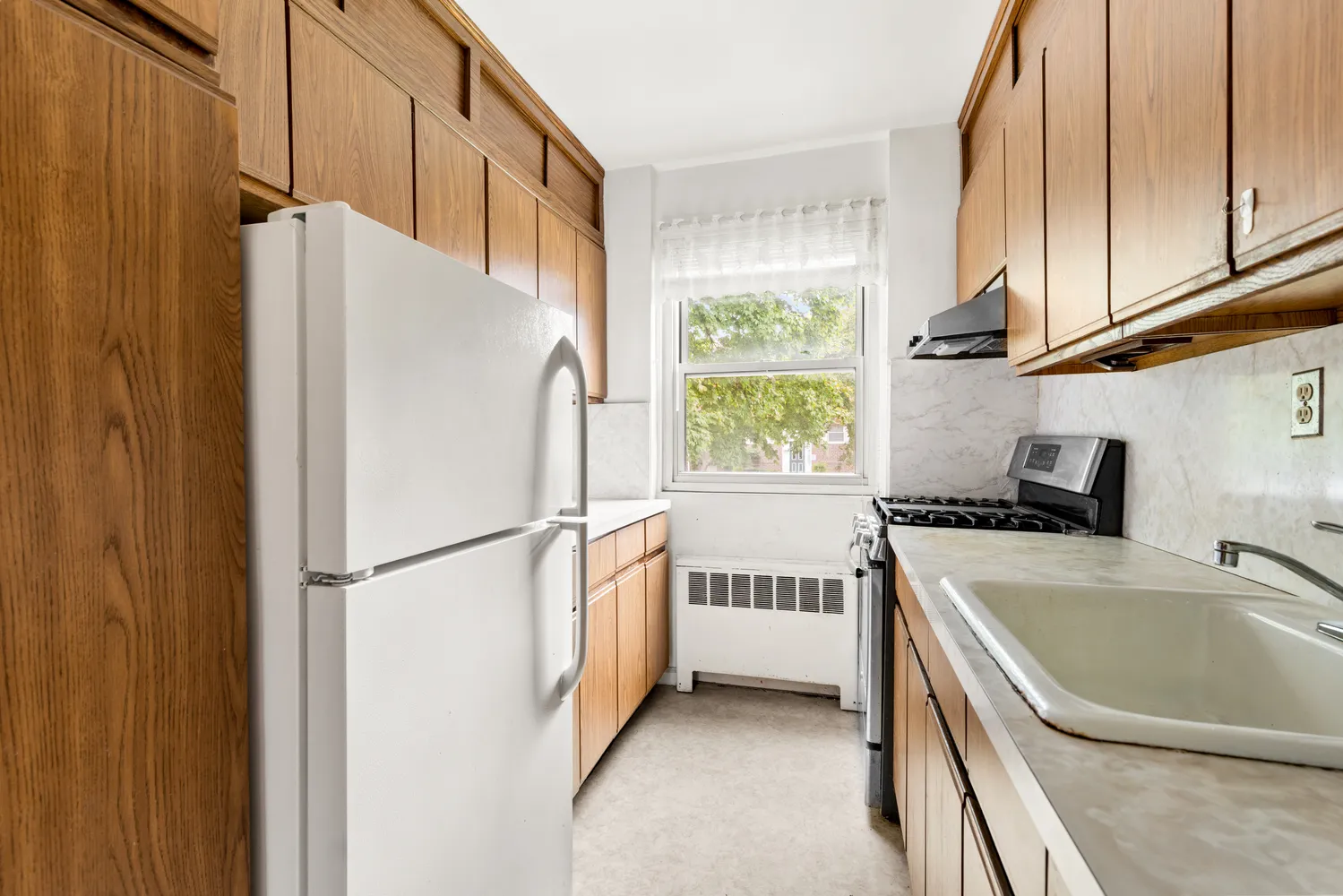 a white refrigerator freezer sitting inside of a kitchen