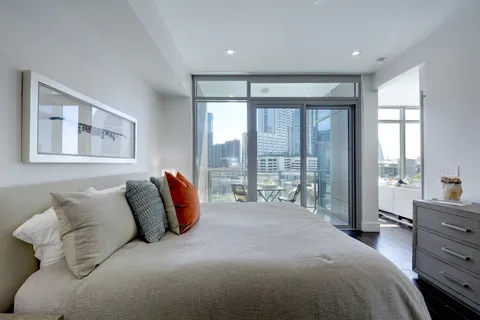 a bedroom with a large bed and a large window
