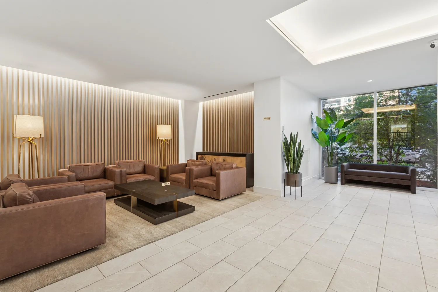 a living room with furniture and a potted plant