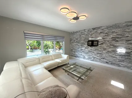 a living room with couches bookshelf and a fireplace