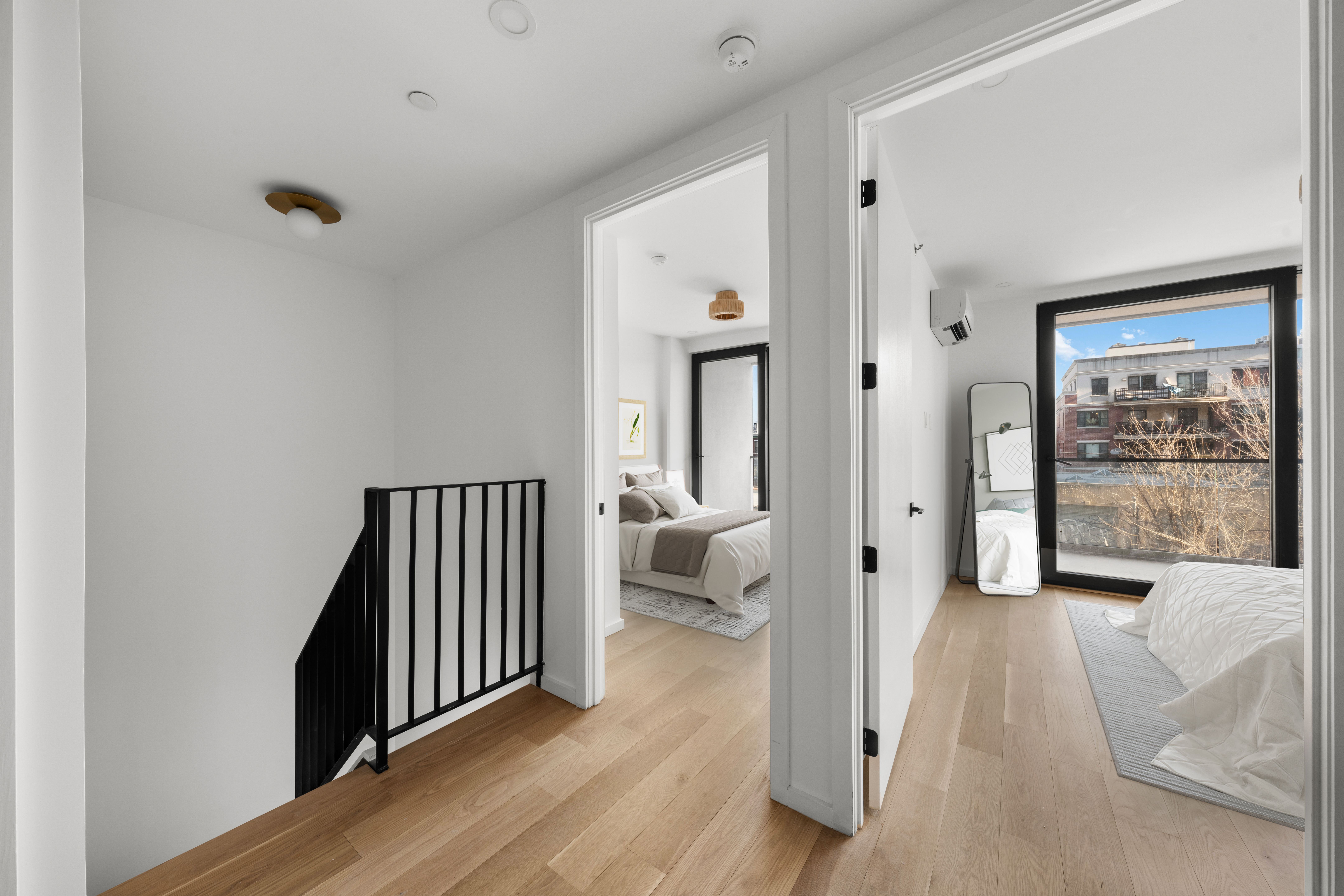 14-35 Broadway, Unit 1A Queens, NY 11106 - Photo 13 of 20 a view of a hallway with wooden floor and a bedroom