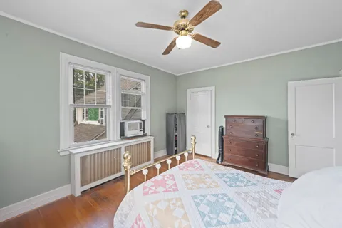 a bedroom with a bed closet and a window