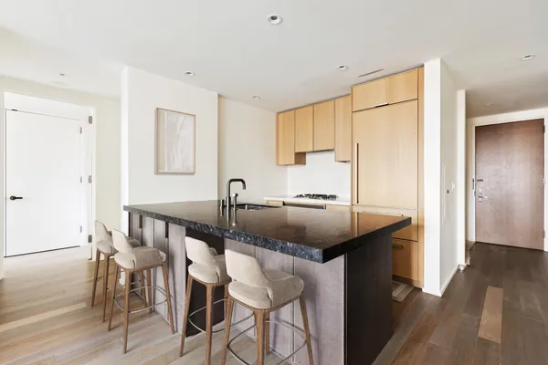 a kitchen with a sink cabinets and wooden floor