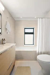 a bathroom with a sink a toilet and window