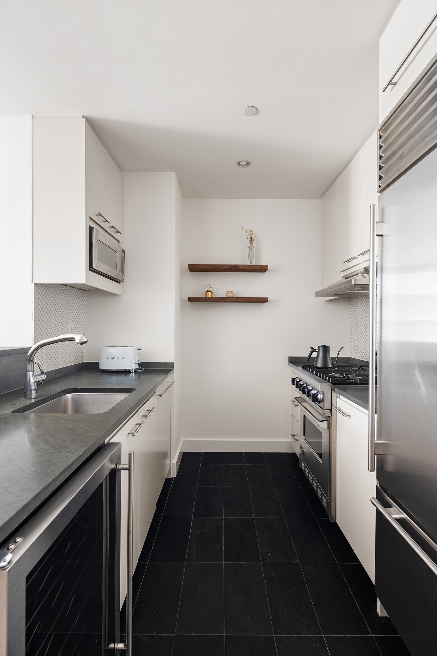 255 Hudson Street, Unit 7C Manhattan, NY 10013 - Photo 5 of 9 a kitchen with a stove sink and refrigerator
