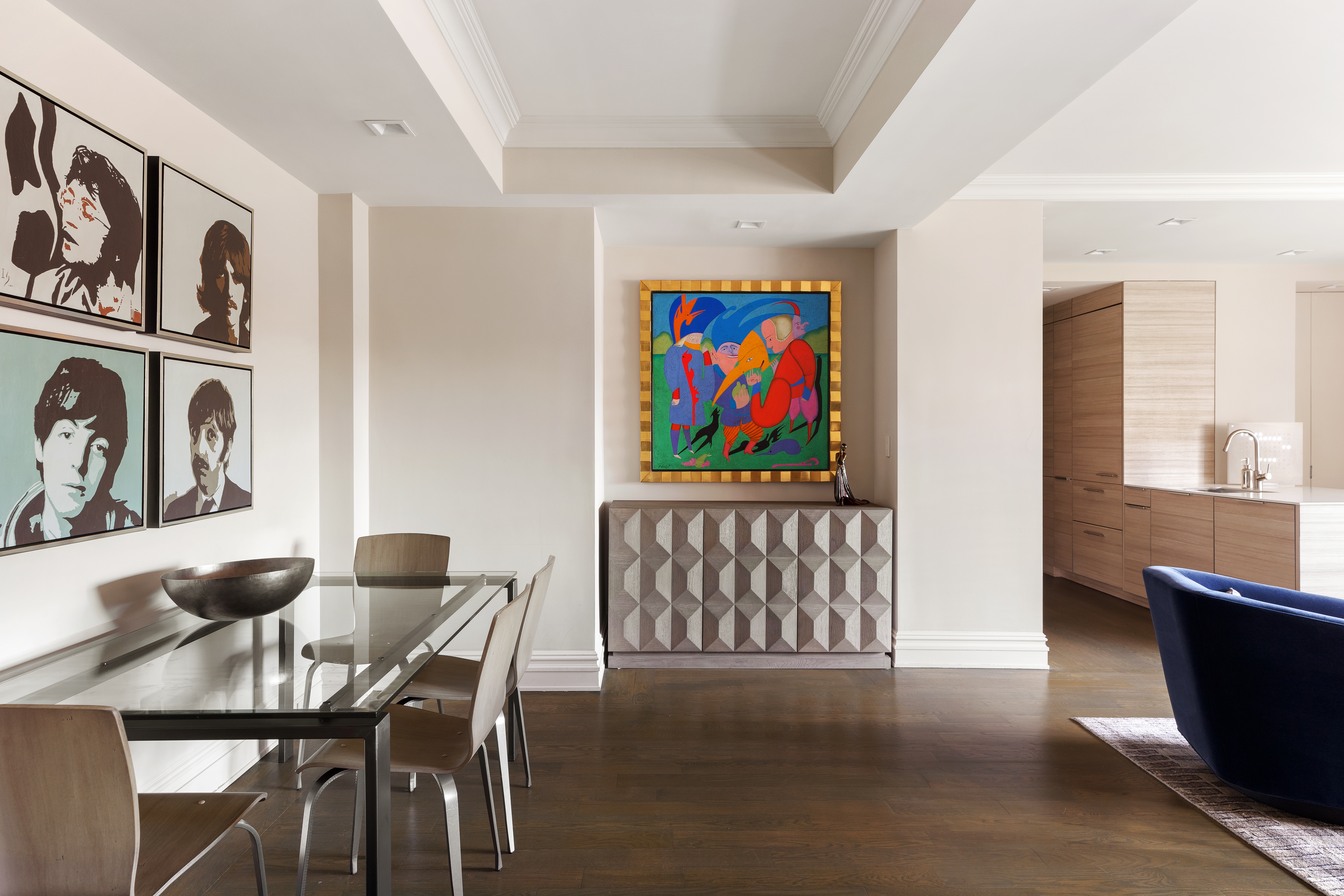 25 East 83rd Street, Unit 10D Manhattan, NY 10028 - Photo 3 of 17 a living room with furniture a dining table and paintings on the wall