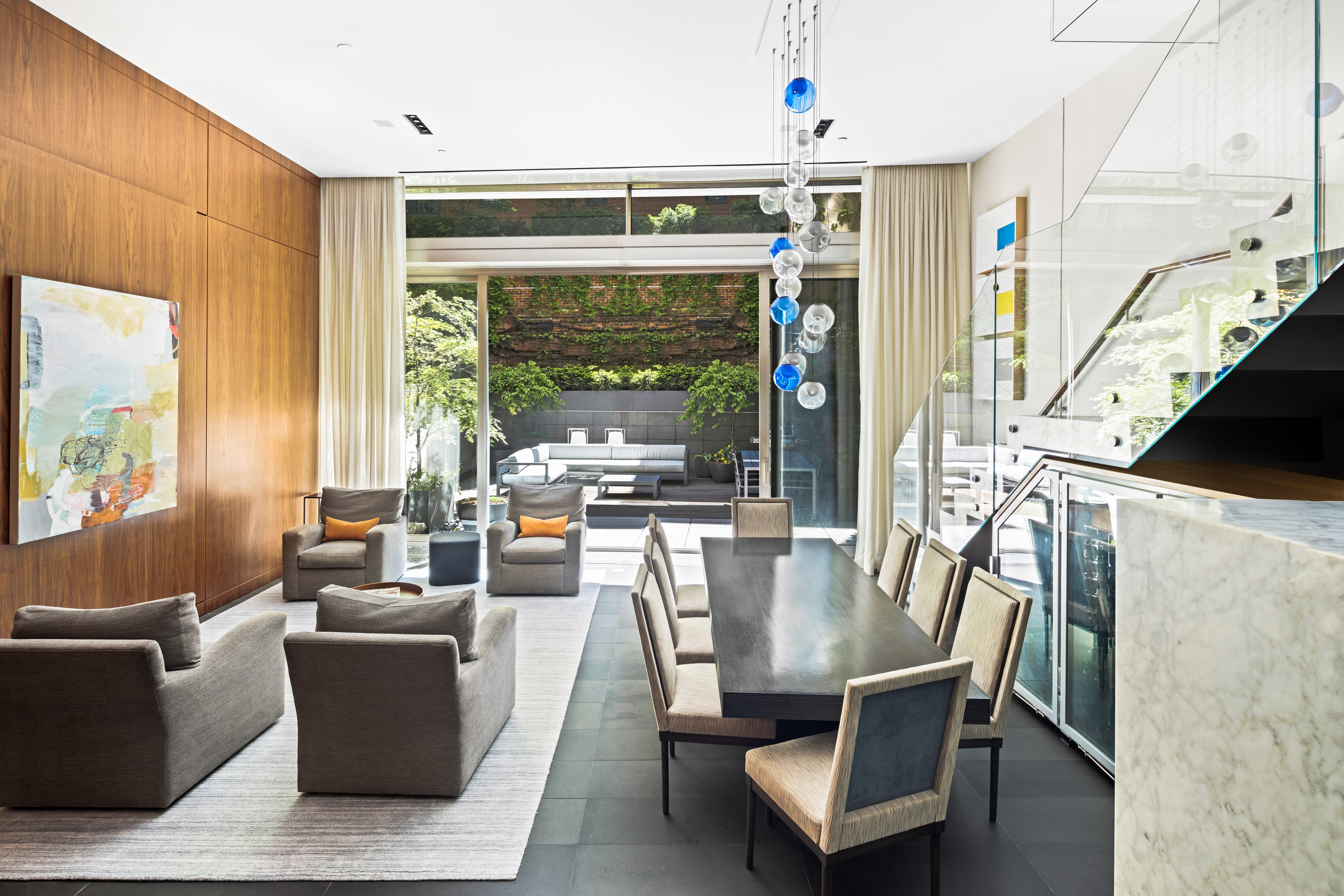 33 Vestry Street, Unit TH1 Manhattan, NY 10013 - Photo 1 of 17 a dining room with furniture large windows and a chandelier