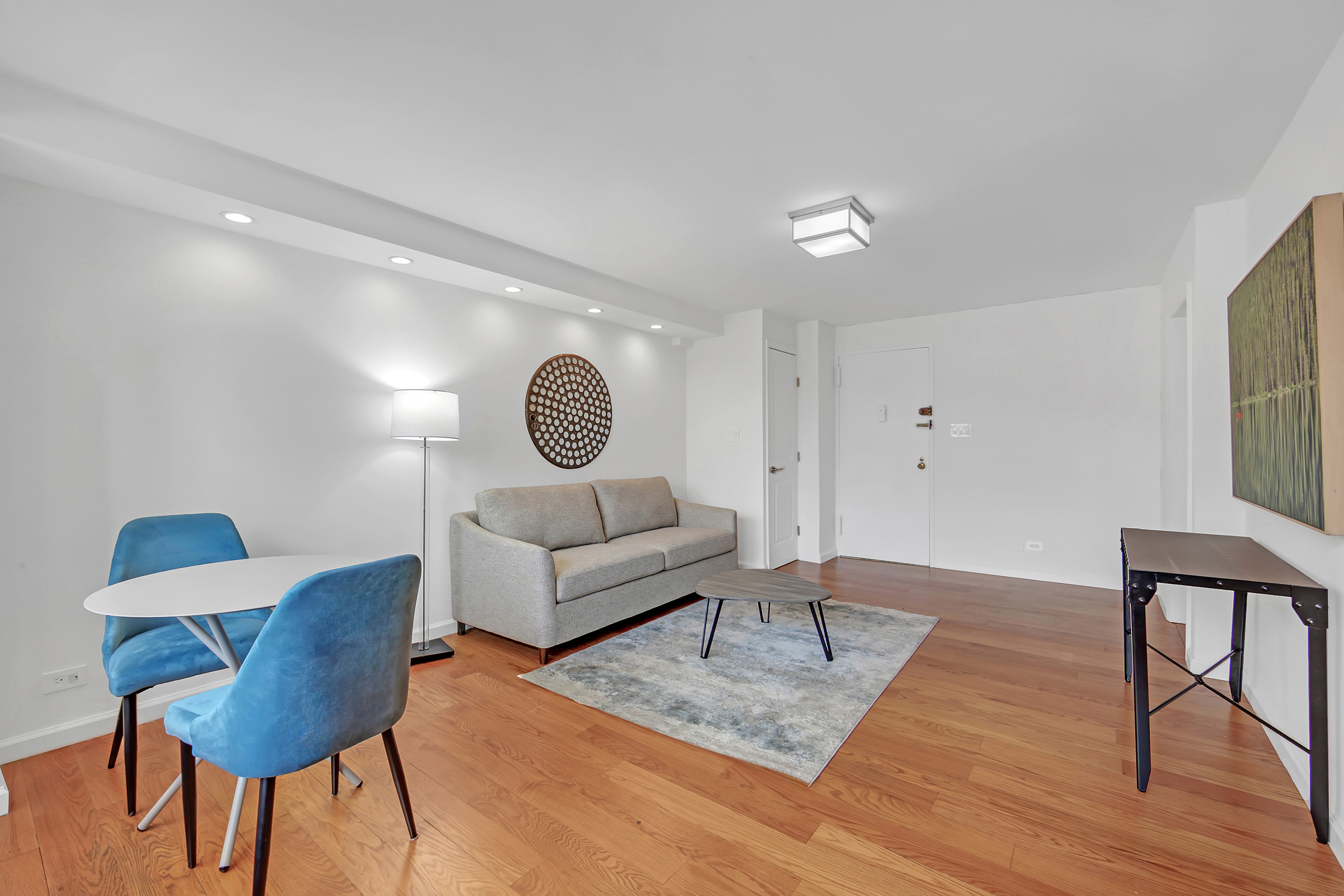 520 East 81st Street, Unit 14C Manhattan, NY 10028 - Photo 5 of 13 a living room with furniture and wooden floor