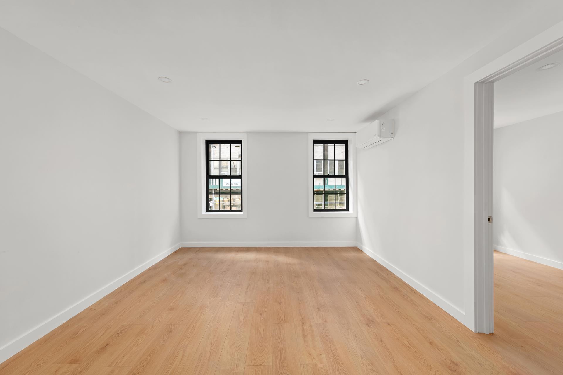 227 East 21st Street, Unit 2F Manhattan, NY 10010 - Photo 1 of 7 an empty room with windows