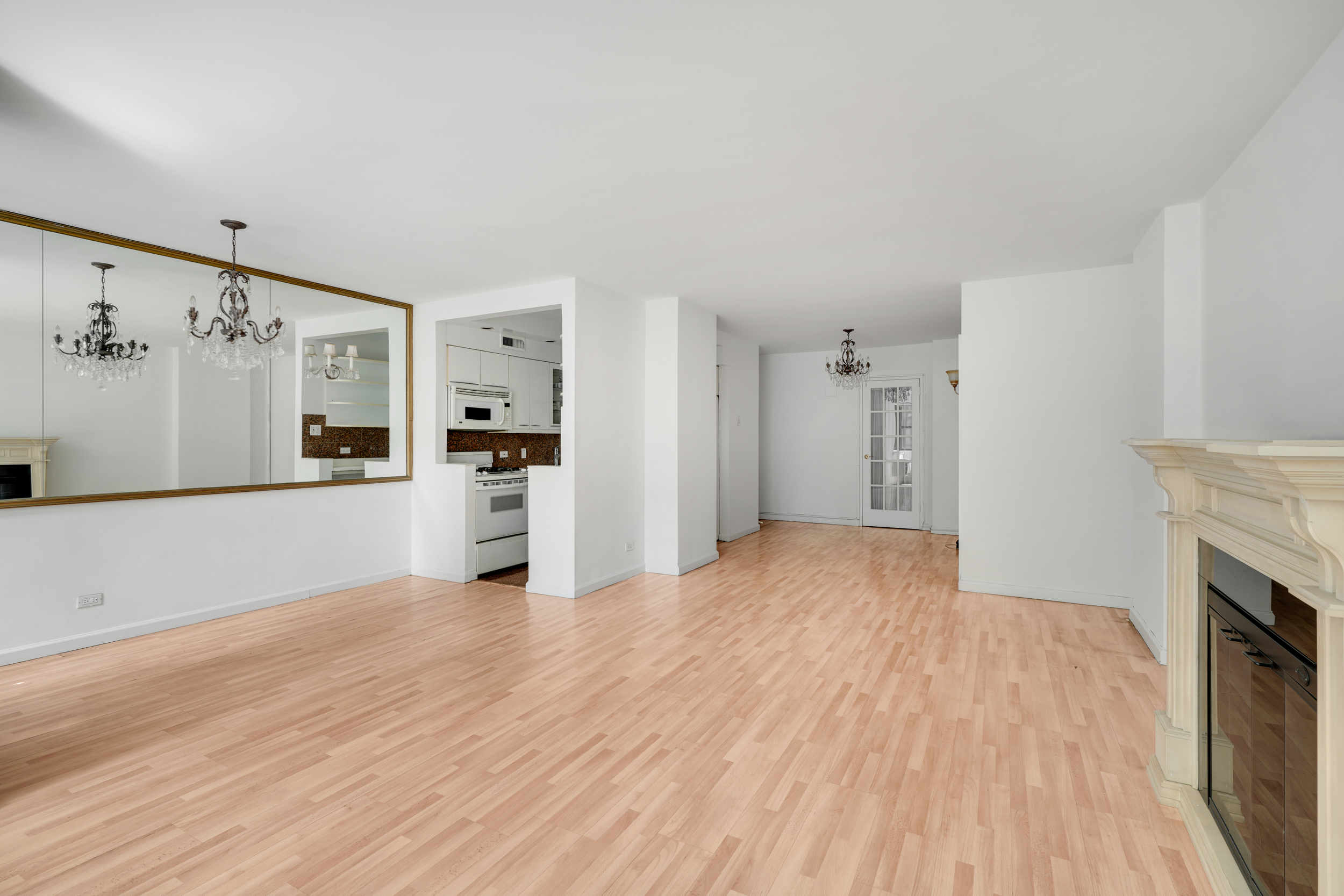 357 East 57th Street, Unit 5D Manhattan, NY 10022 - Photo 5 of 23 a view of a kitchen with a sink a refrigerator and a stove top oven