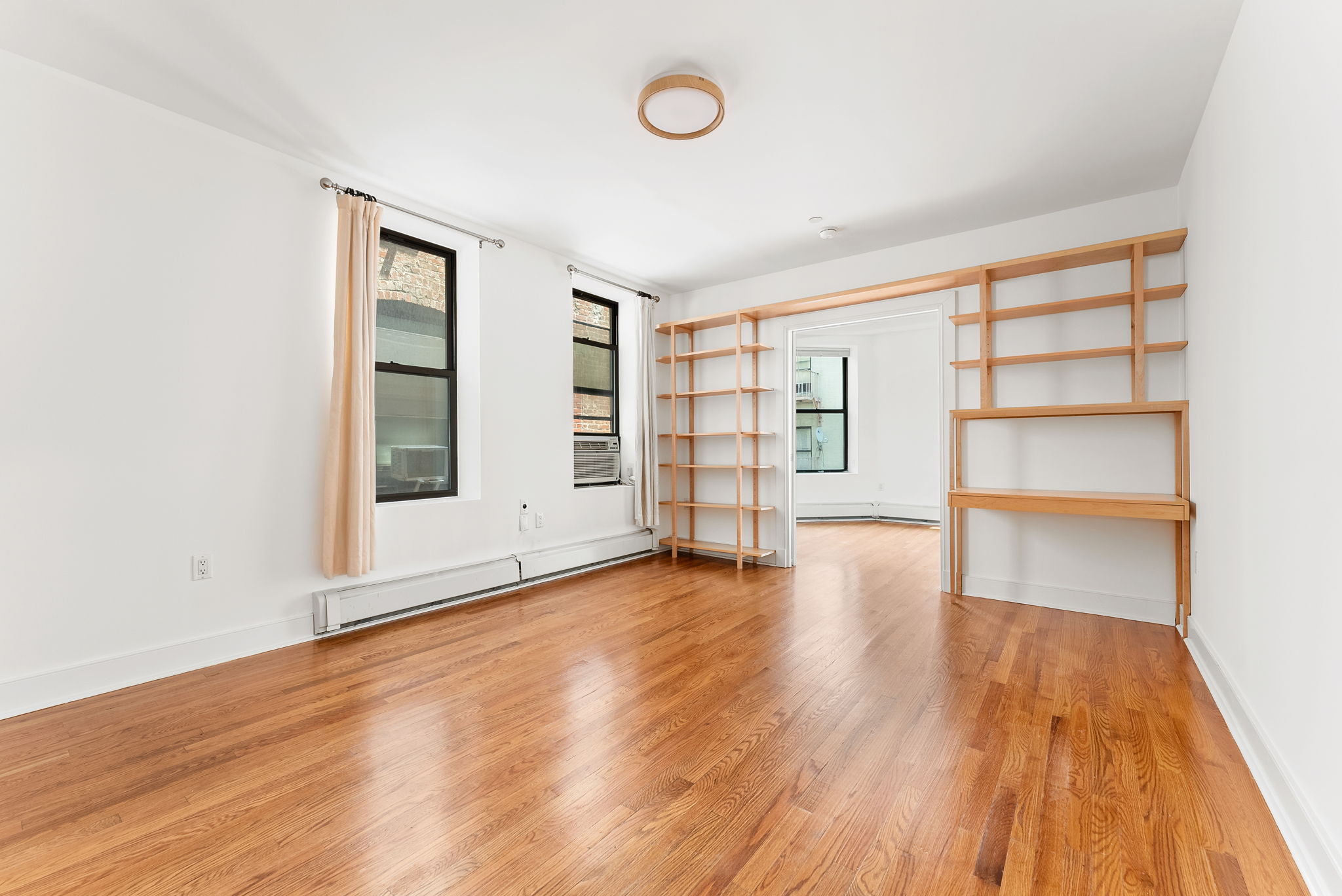 305 West 150th Street, Unit 511 Manhattan, NY 10039 - Photo 2 of 17 wooden floor in an empty room with a window