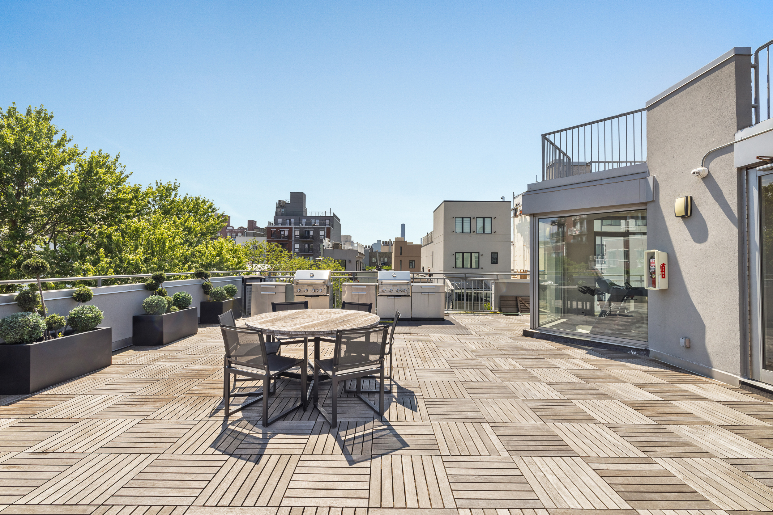 192 Spencer Street, Unit 3A Brooklyn, NY 11205 - Photo 10 of 12 a view of a patio with a dining table and chairs with a patio