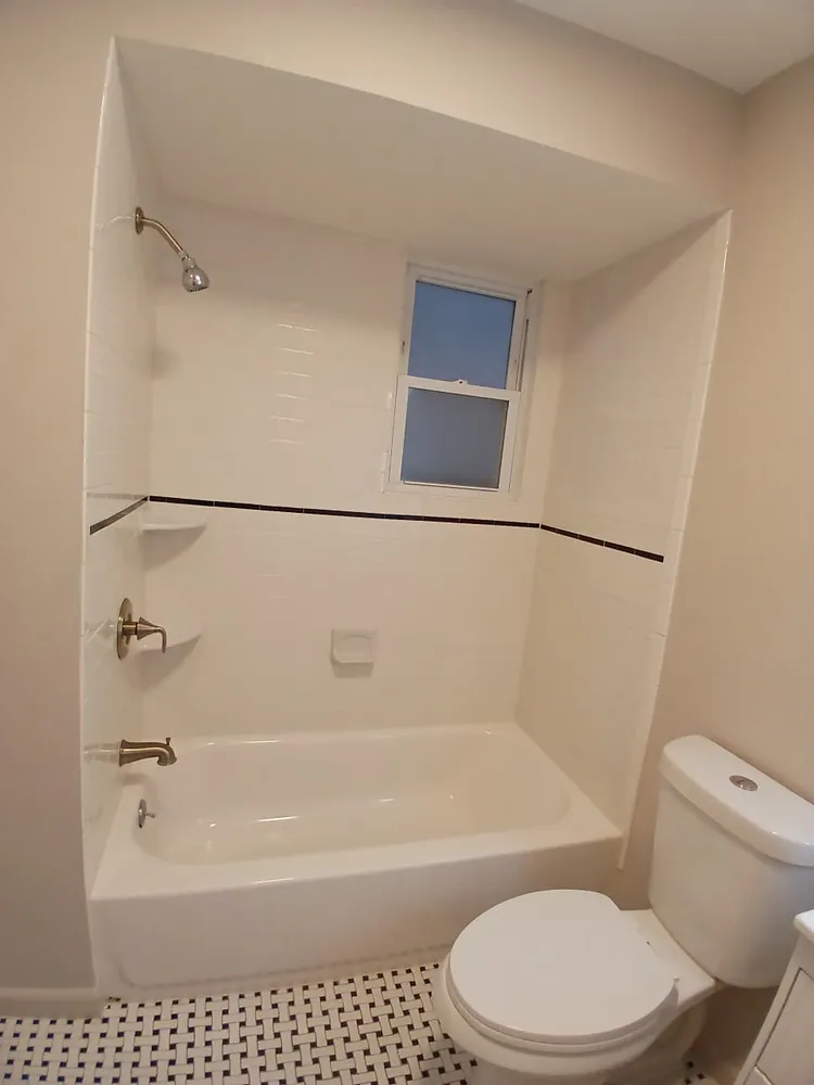 a white toilet sitting next to a bath tub