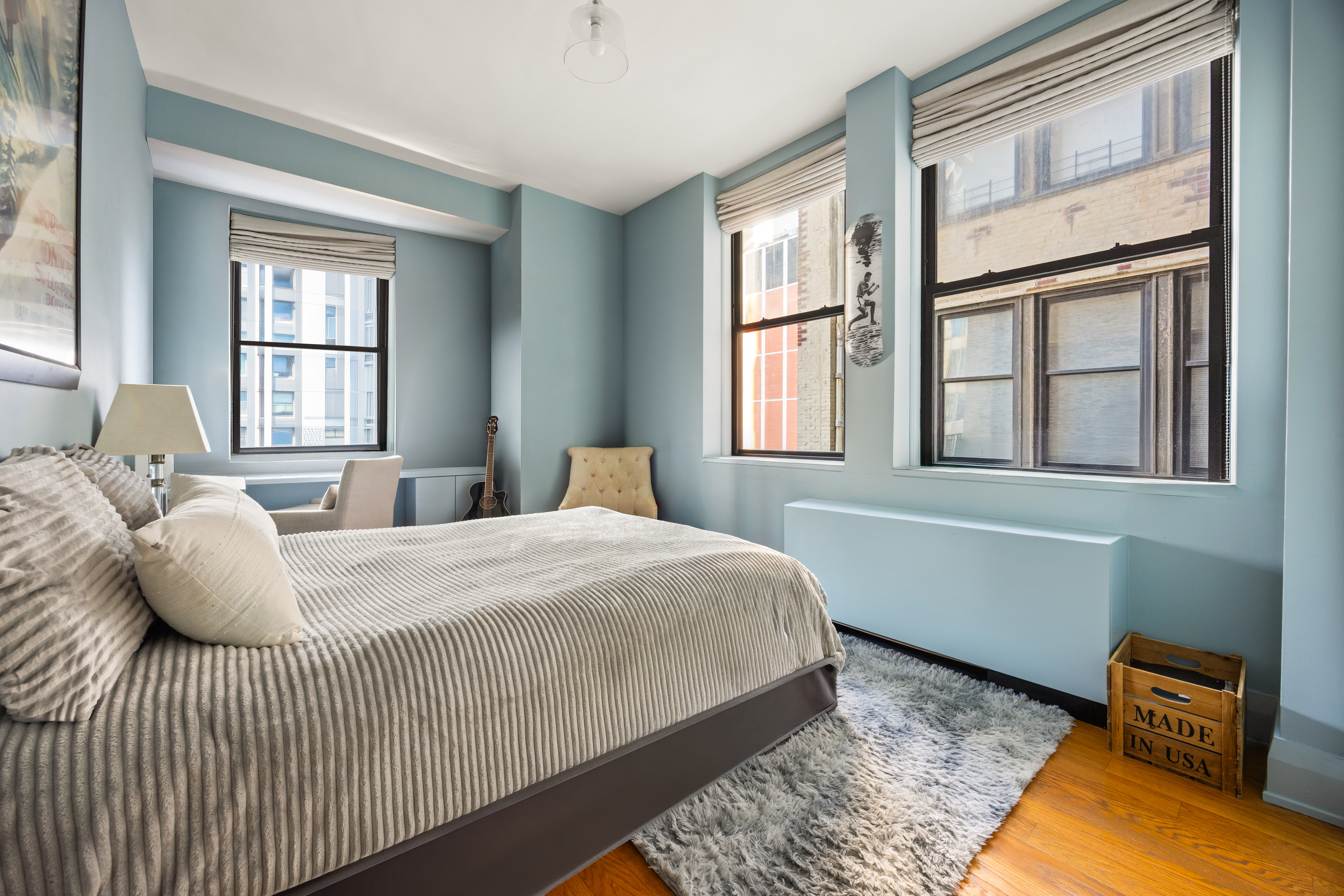 150 Nassau Street, Unit 17D Manhattan, NY 10038 - Photo 6 of 16 a bedroom with a bed and wooden floor