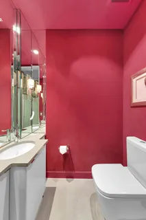a bathroom with a sink a toilet a mirror and vanity