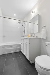 a bathroom with a sink a toilet and bathtub