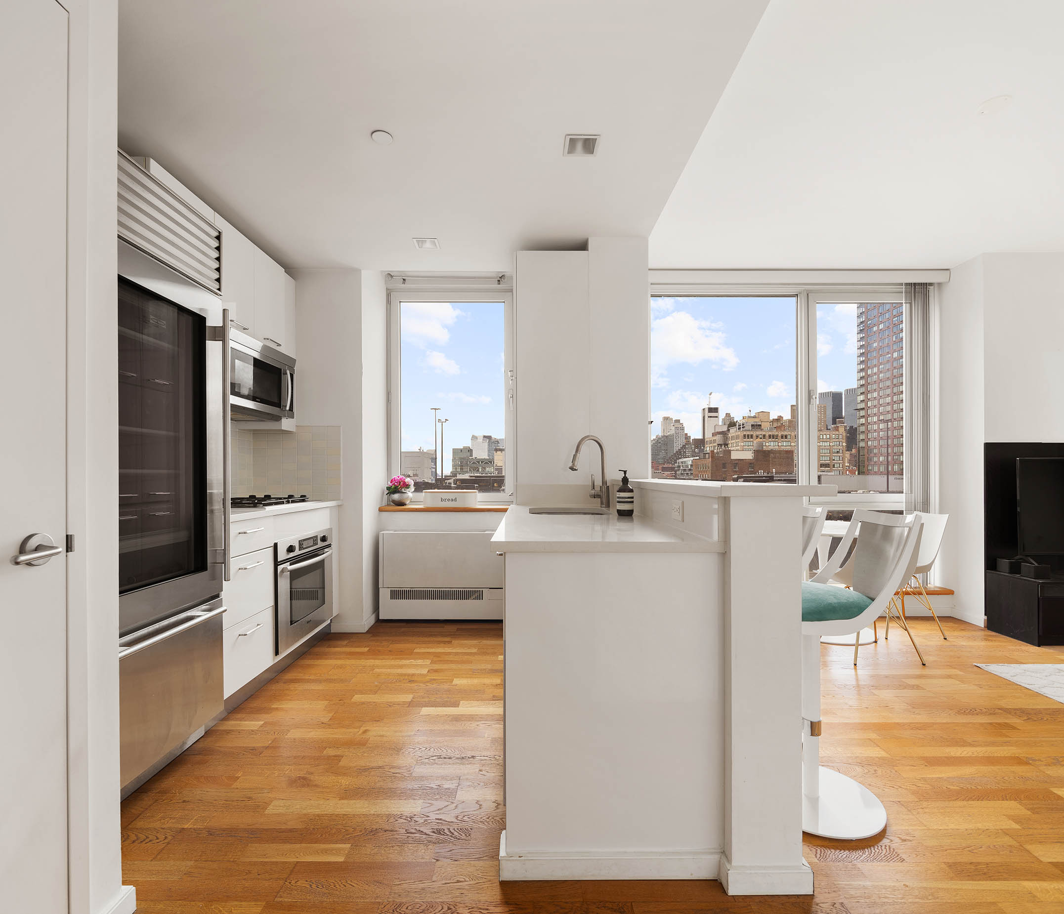 635 West 42nd Street, Unit 7F Manhattan, NY 10036 - Photo 3 of 7 a kitchen with a sink cabinets and stainless steel appliances