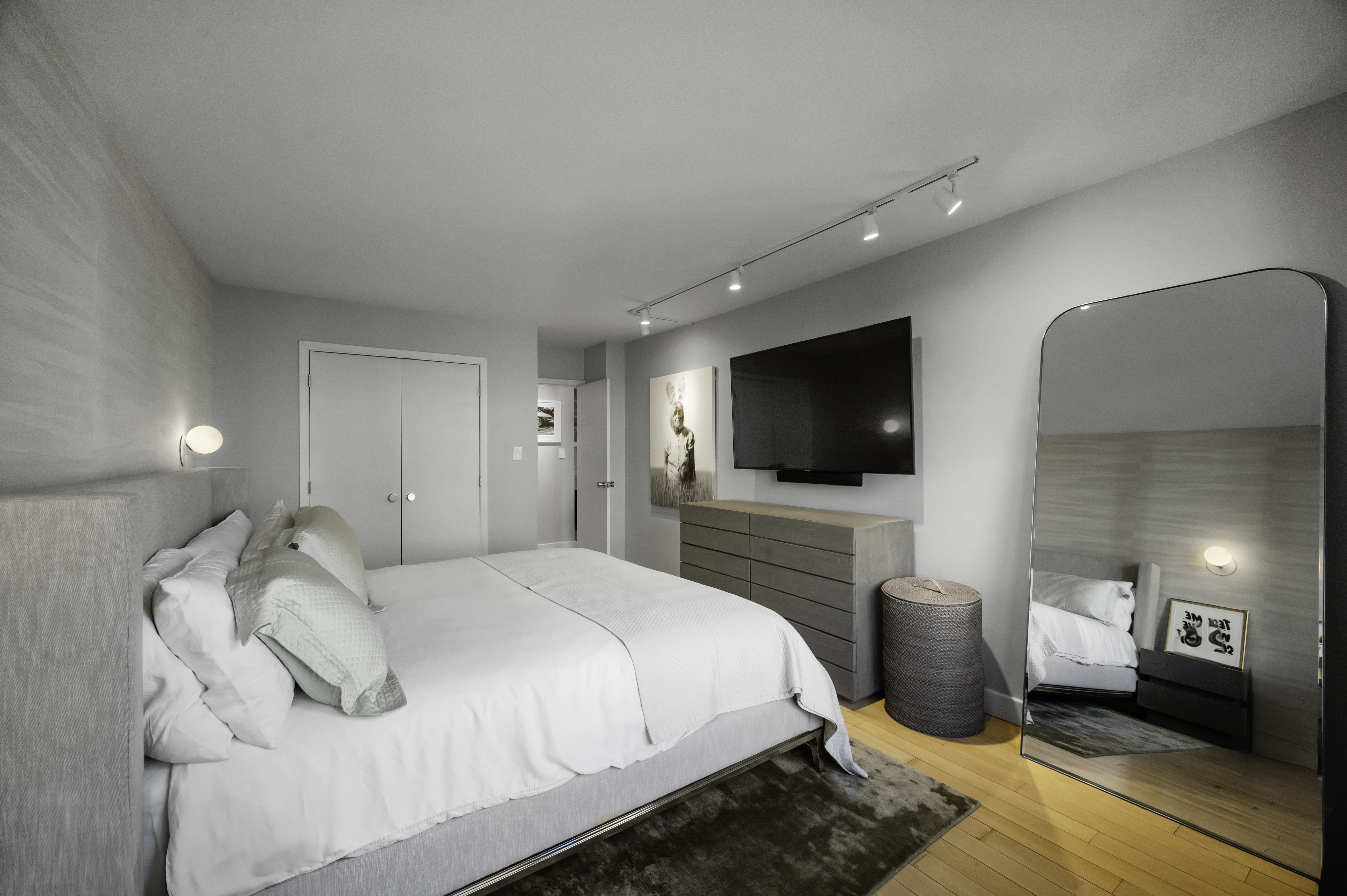 301 East 62nd Street, Unit 7K Manhattan, NY 10065 - Photo 5 of 14 a bedroom with a bed and a flat screen tv