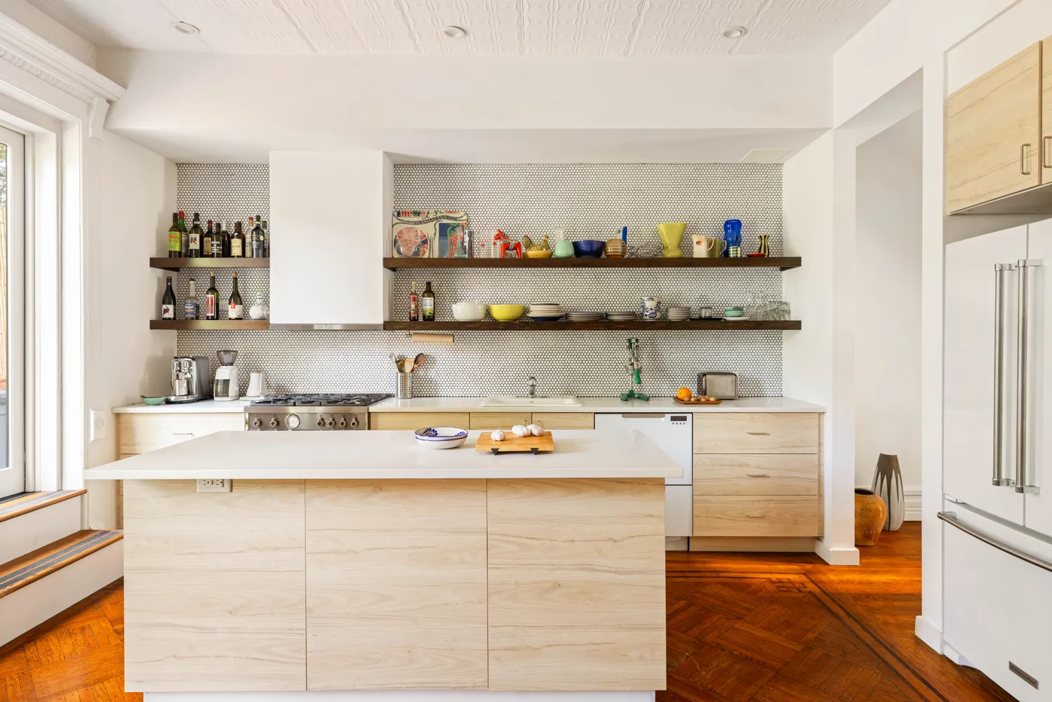 a living room with granite countertop cabinets and a wooden floor
