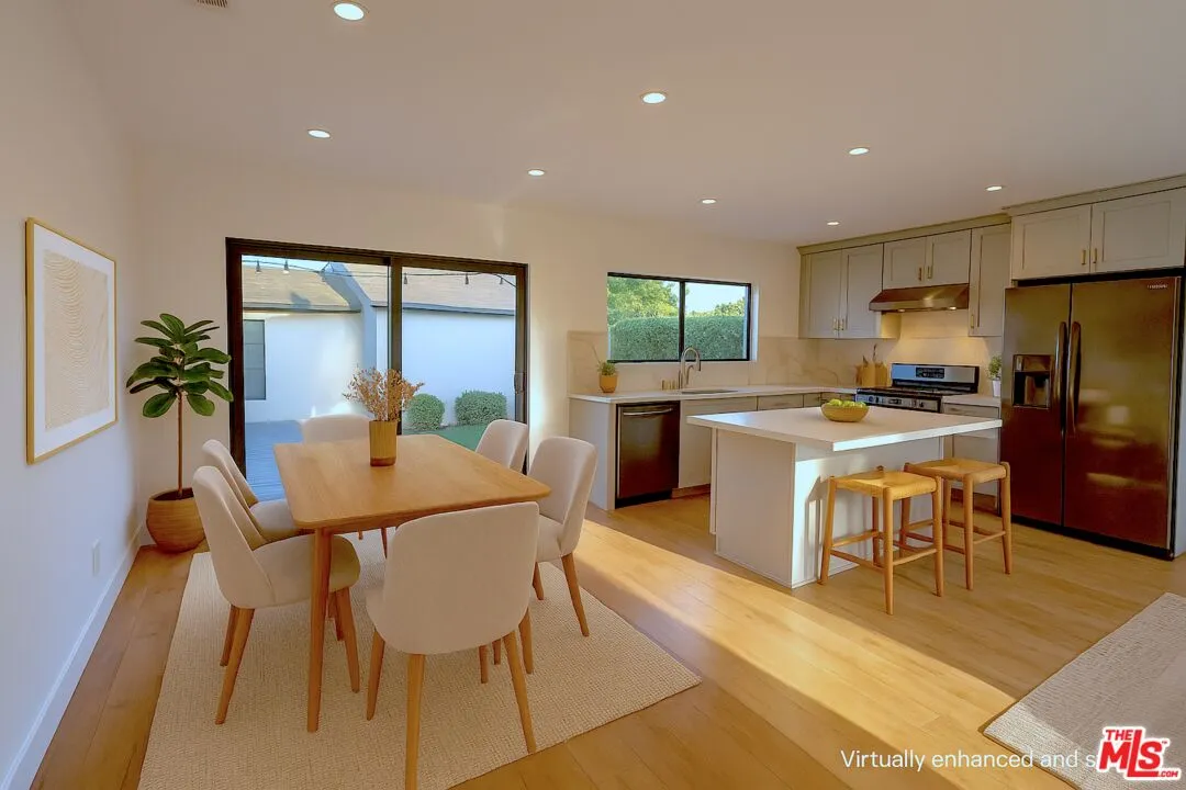 a view of a bedroom with wooden floor and windows