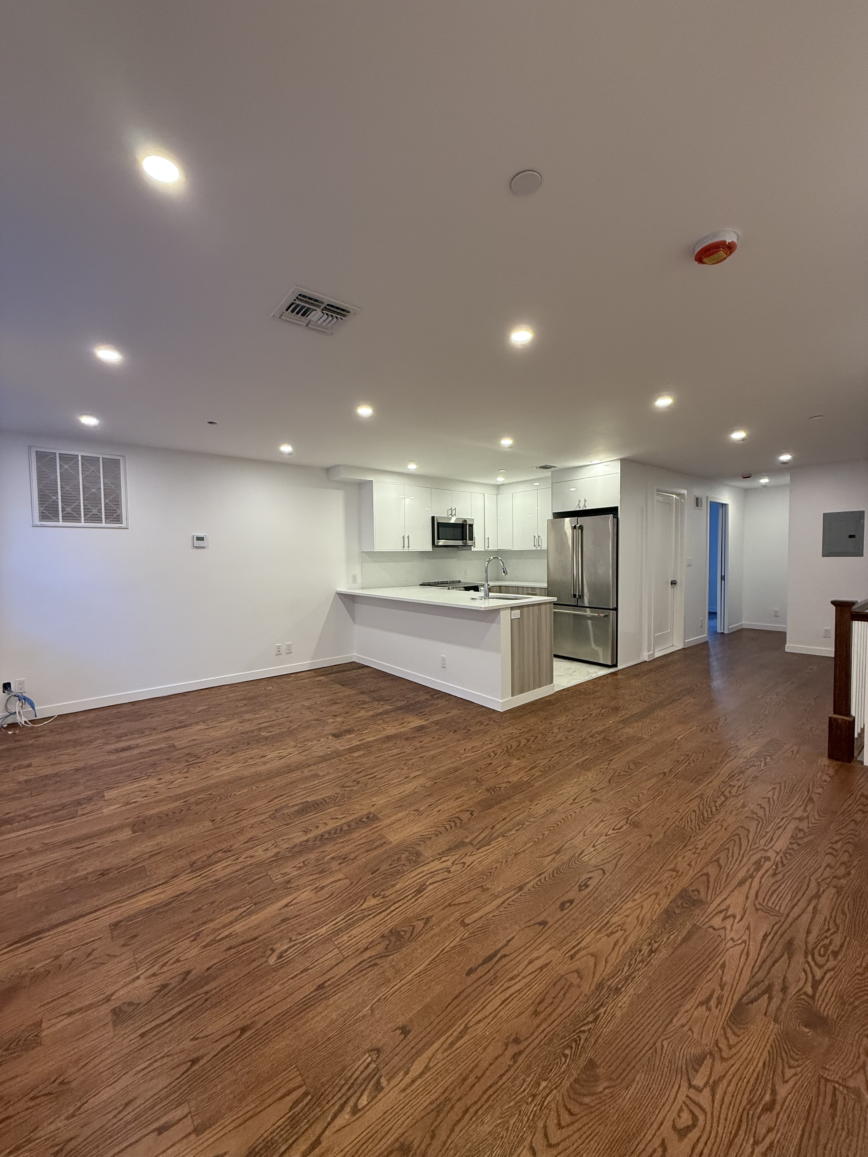 109 President Street, Unit 1 Brooklyn, NY 11231 - Photo 4 of 16 a view of kitchen and empty room with wooden floor