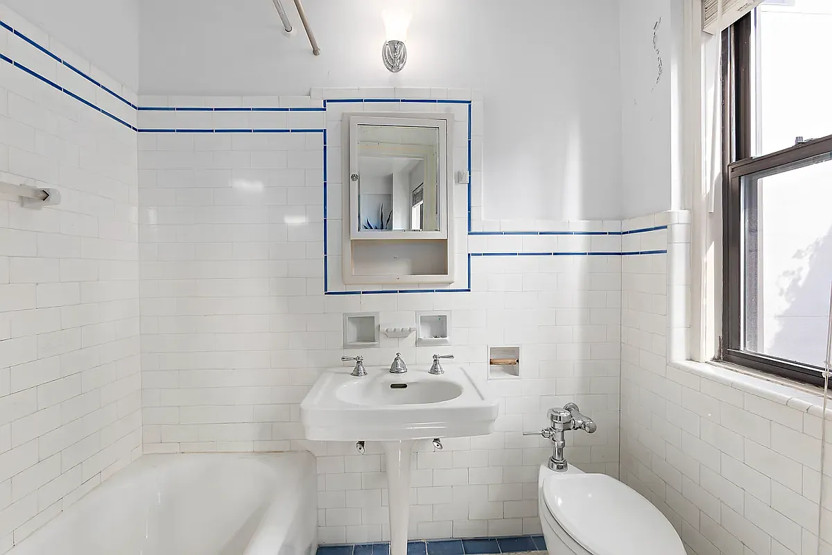 457 West 57th Street, Unit 912 Manhattan, NY 10019 - Photo 4 of 11 a bathroom with a sink toilet and shower
