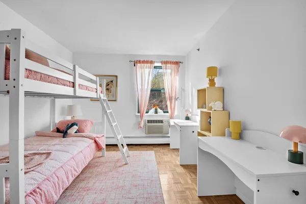 a bedroom with a bed and large windows