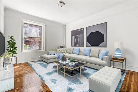 a living room with furniture and a potted plant