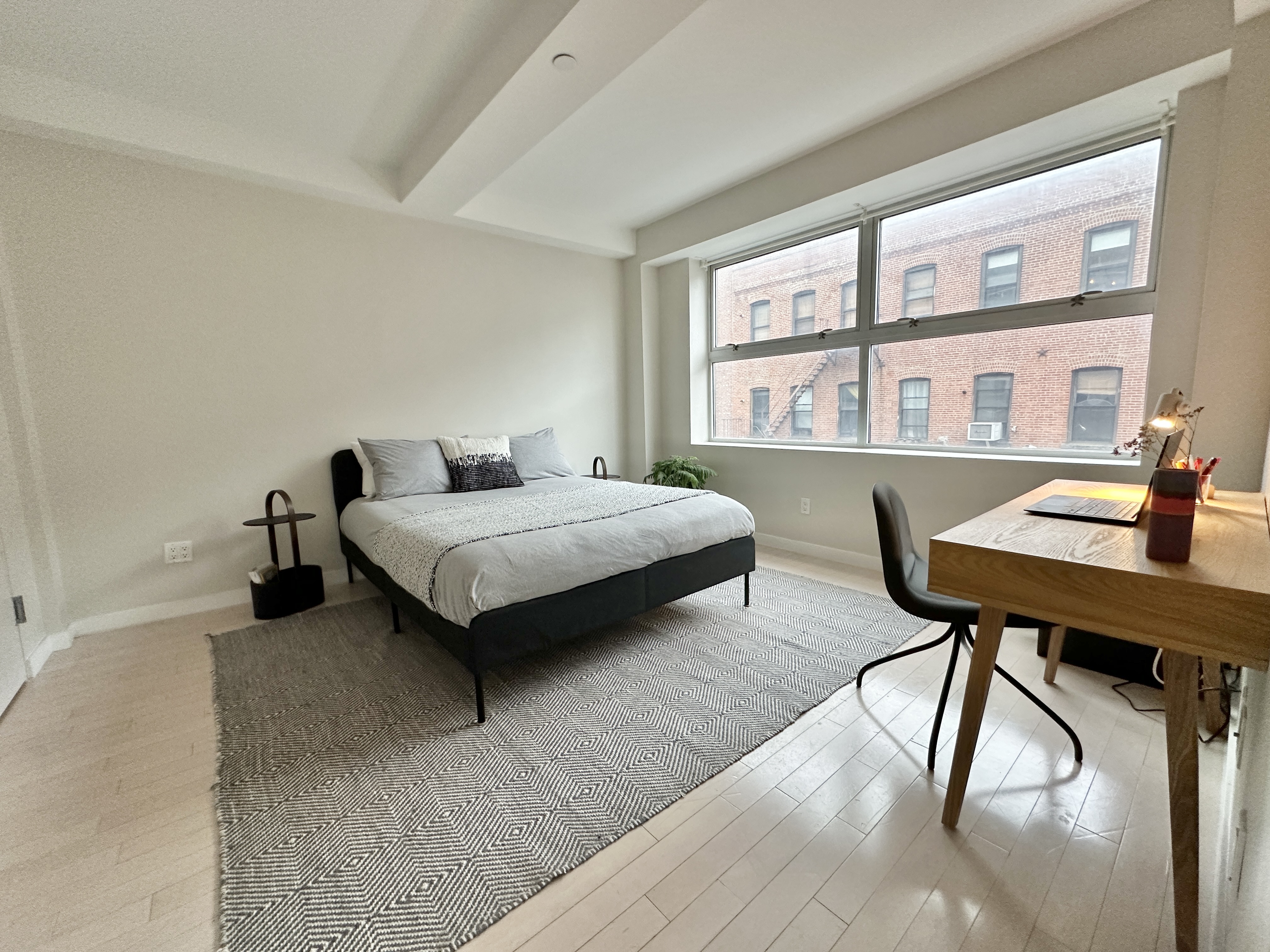 100 North 3rd Street, Unit 3E Brooklyn, NY 11249 - Photo 7 of 15 a bedroom with furniture and a large window