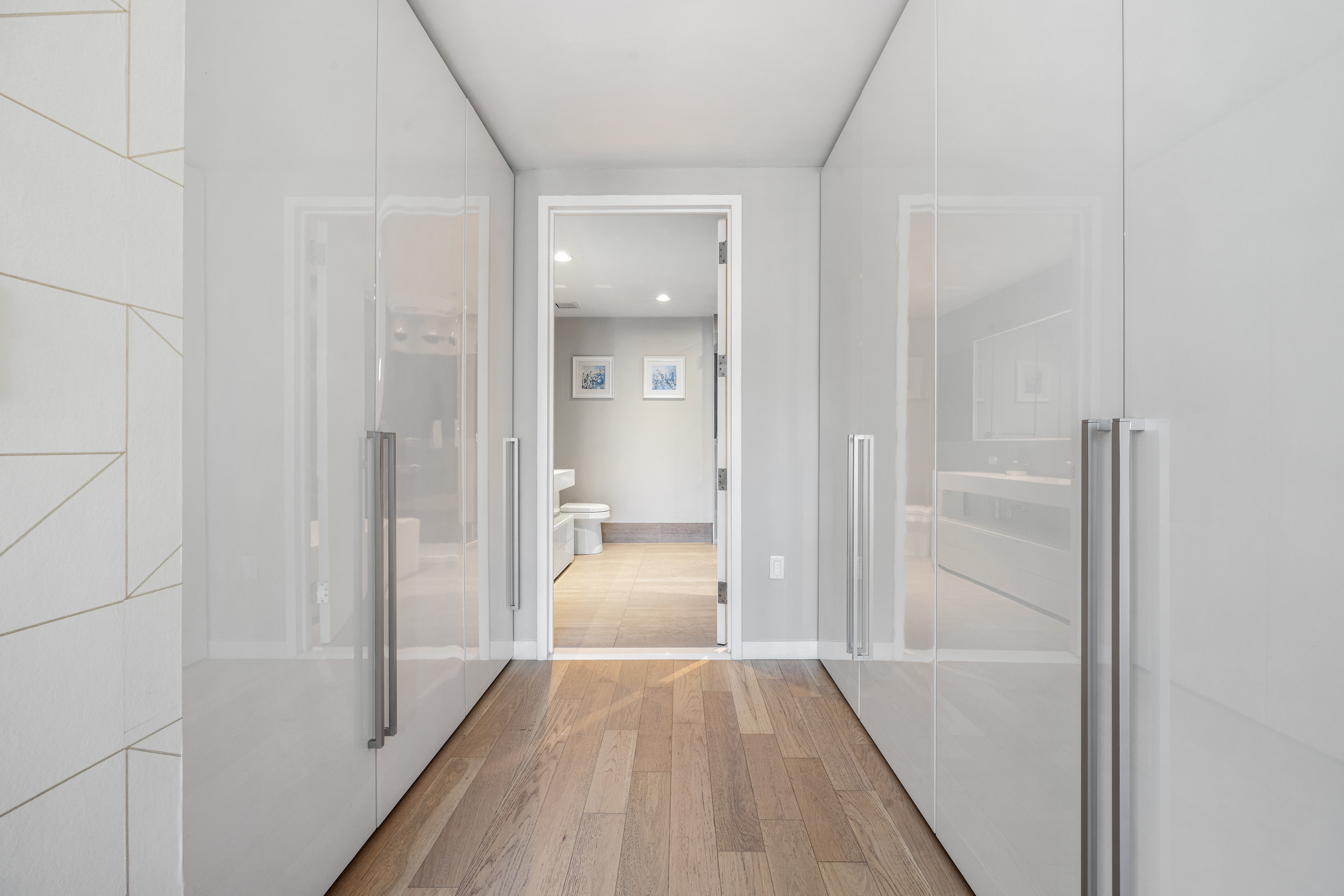 540 West 49th Street, Unit PH1N Manhattan, NY 10019 - Photo 10 of 18 a view of a hallway with wooden floor and a bathroom