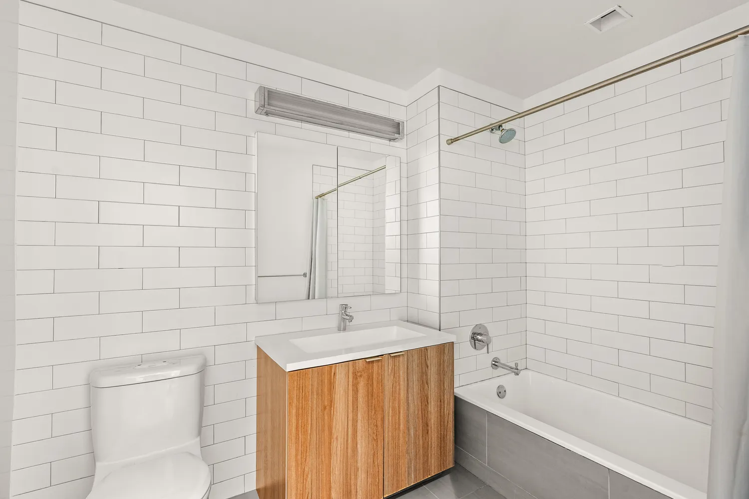 a bathroom with a bathtub a shower a toilet and a sink