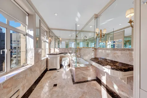 a kitchen with stainless steel appliances granite countertop a stove and a refrigerator