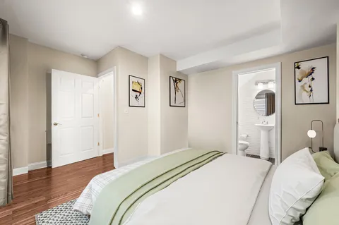 a bedroom with a bed and wooden floor