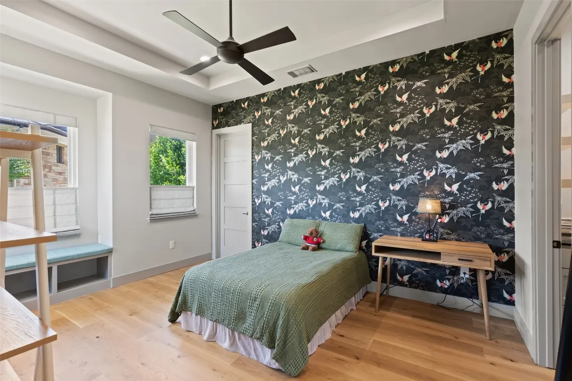 a bedroom with a bed and a chandelier