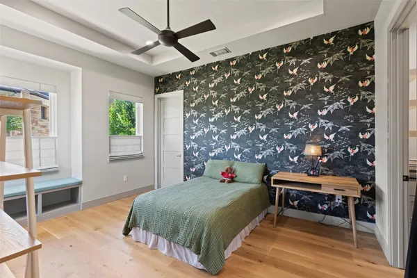 a bedroom with a bed and a chandelier