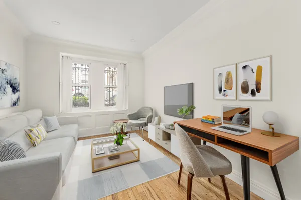 a living room with furniture and wooden floor