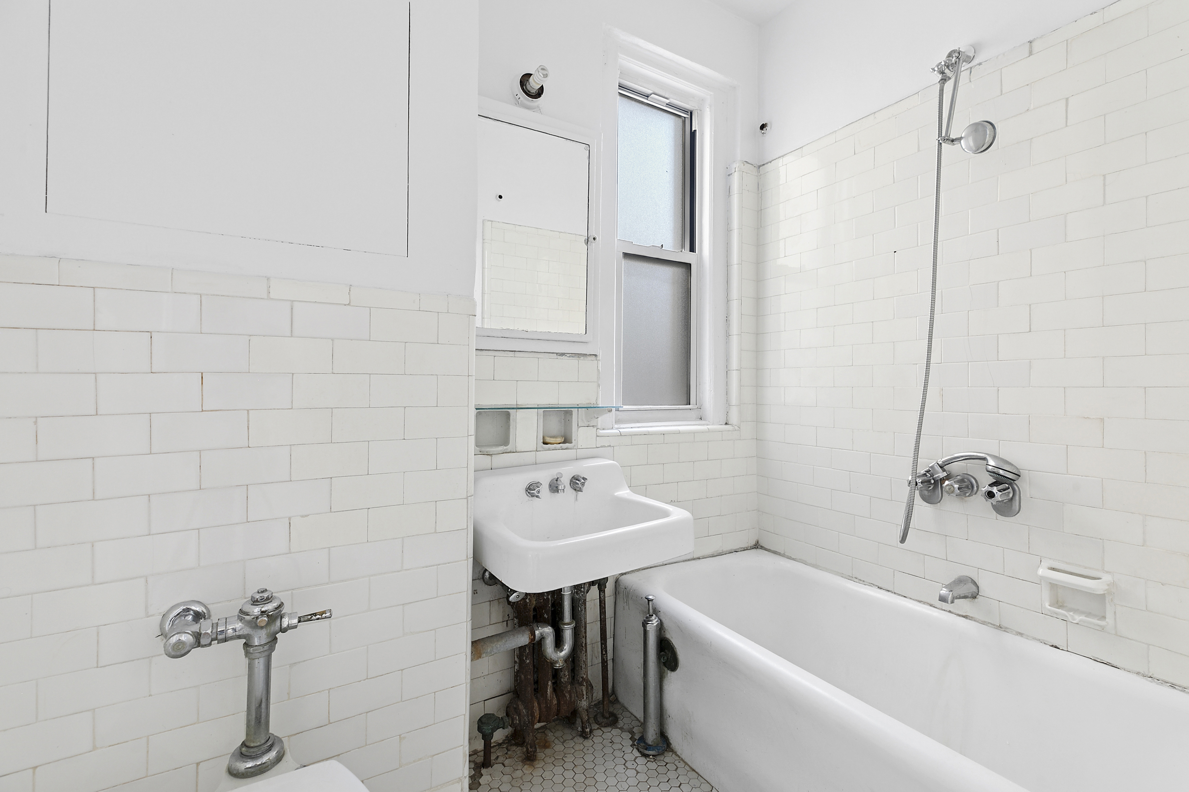 250 West 94th Street, Unit 8J Manhattan, NY 10025 - Photo 9 of 19 a bathroom with a sink a toilet and shower